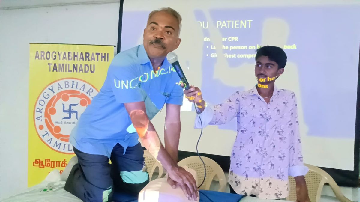 Dr. Anand demonstrating CPR chest compressions during a training session